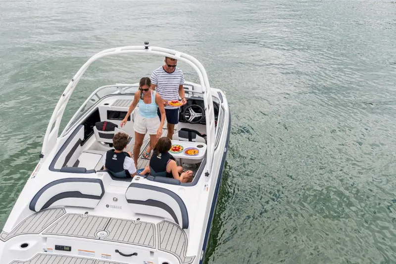 Slide: The Image of Family enjoying a day on the water in a 2023 Yamaha Outboards 195S boat. - 4
