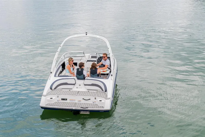 Slide: The Image of 2023 Yamaha Outboards 195S boat with passengers cruising on a calm lake. - 7