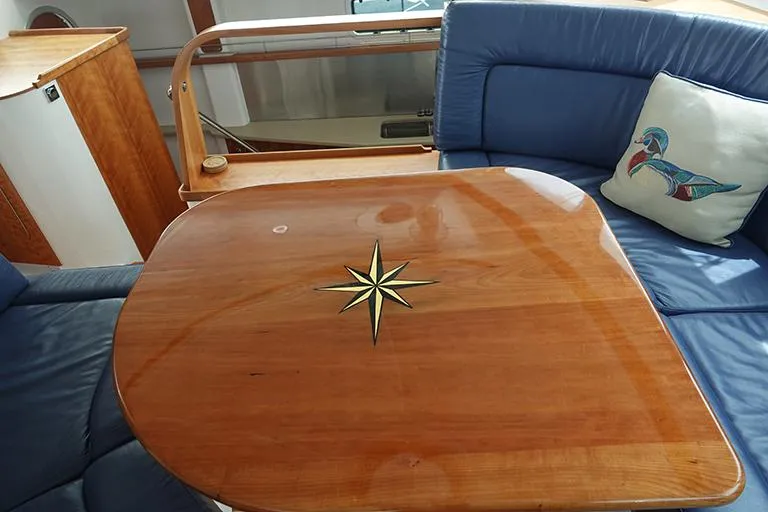 Slide: The Image of Wooden table with compass rose in a 2007 PDQ MV-41 yacht. - 3