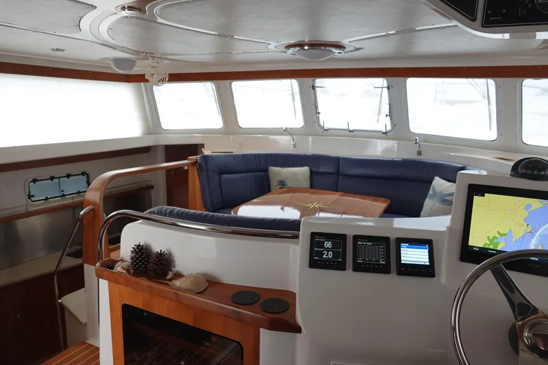 Slide: The Image of Interior of a 2007 PDQ MV-41 yacht with blue seating area. - 4