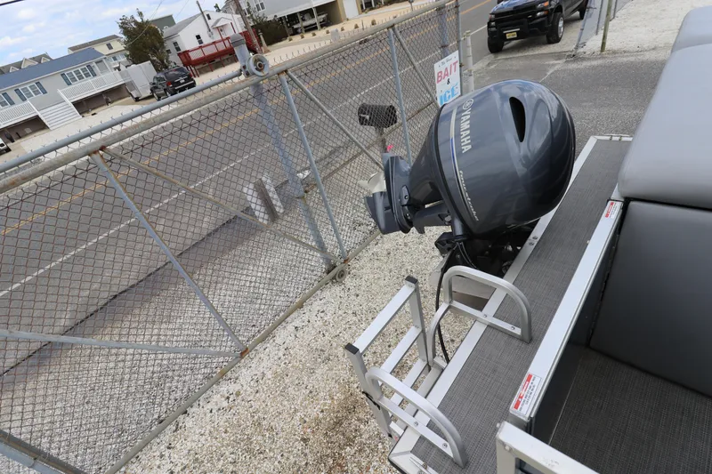 Slide: The Image of 2019 Bentley Pontoons 240/243 Cruise with Yamaha motor near a chain-link fence. - 11