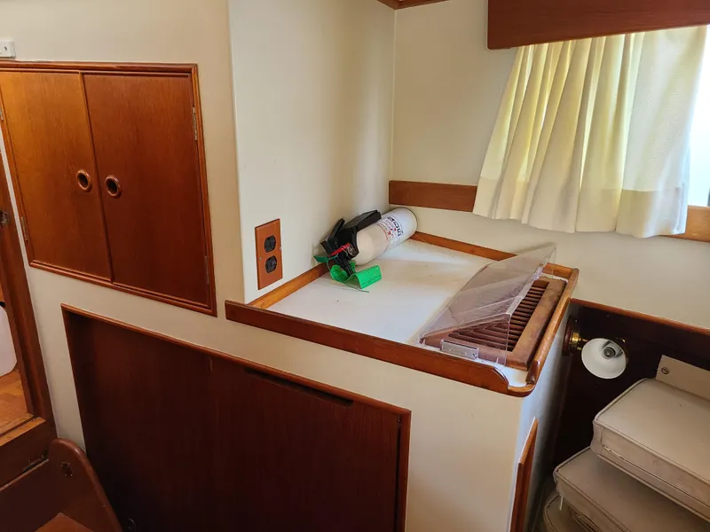 Slide: The Image of Interior of 1989 Grand Banks 42 Classic with wooden cabinetry and fire extinguisher. - 12