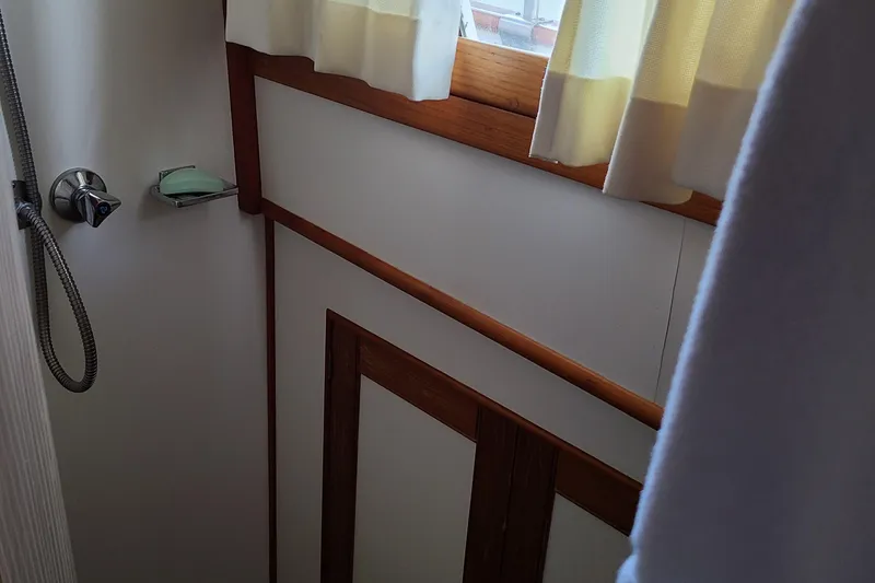 Slide: The Image of 1989 Grand Banks 42 Classic bathroom with wooden trim and shower. - 15