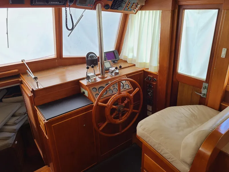 Slide: The Image of 1989 Grand Banks 42 Classic helm station with wooden steering wheel and navigation instruments. - 2