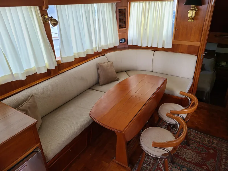 Slide: The Image of Interior of 1989 Grand Banks 42 Classic with cozy seating and wooden table. - 3