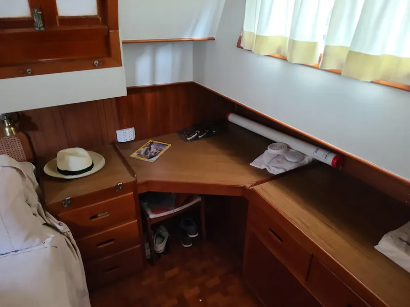 Slide: The Image of 1989 Grand Banks 42 Classic cabin interior with wooden desk and storage. - 4