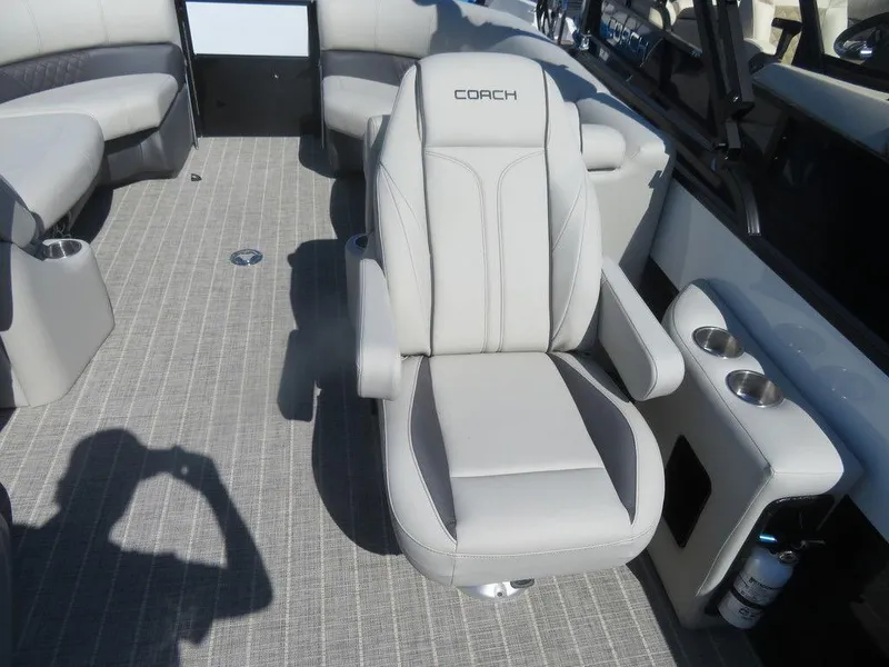 Slide: The Image of 2021 Coach Pontoons 245 RFC-21 interior with captain's chair and seating area. - 17