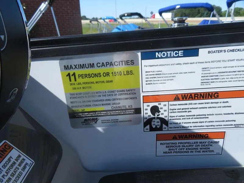 Slide: The Image of 2021 Coach Pontoons 245 RFC-21 capacity and safety labels on dashboard. - 2