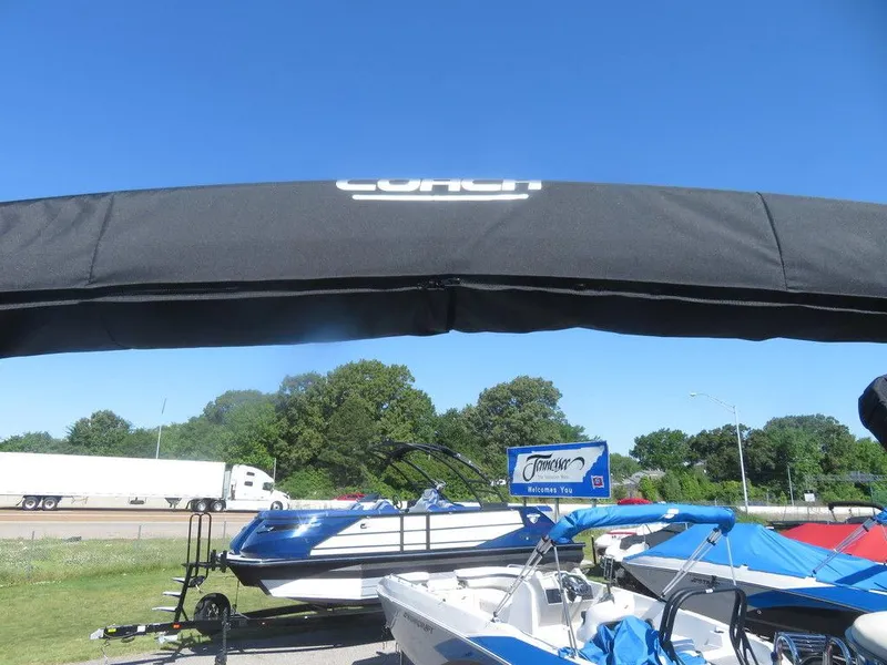 Slide: The Image of 2021 Coach Pontoons 245 RFC-21 boats displayed outdoors under a clear blue sky. - 8