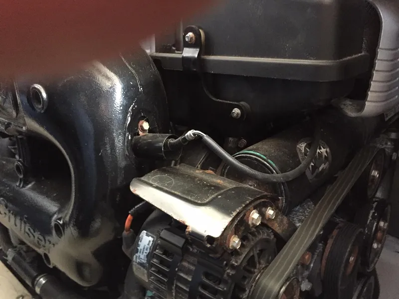 Slide: The Image of Engine components of a 2013 Meridian 341 Sedan boat, featuring belts and wiring. - 16