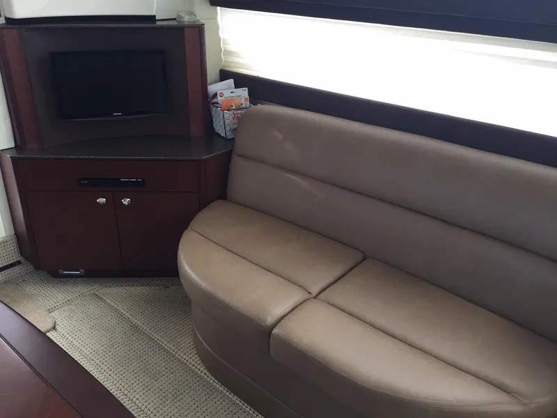Slide: The Image of Interior of 2013 Meridian 341 Sedan with brown leather sofa and small TV cabinet. - 19