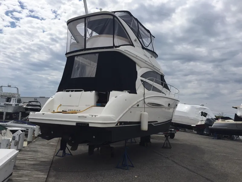 Slide: The Image of 2013 Meridian 341 Sedan yacht on dry dock under cloudy sky. - 2