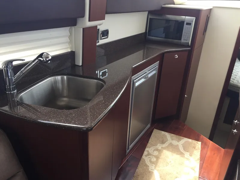 Slide: The Image of 2013 Meridian 341 Sedan yacht kitchen with sink, microwave, and dishwasher. - 20