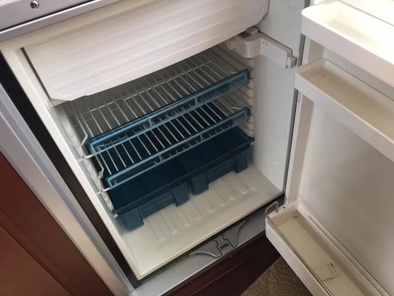 Slide: The Image of Open refrigerator with blue ice trays inside, part of a 2013 Meridian 341 Sedan. - 23