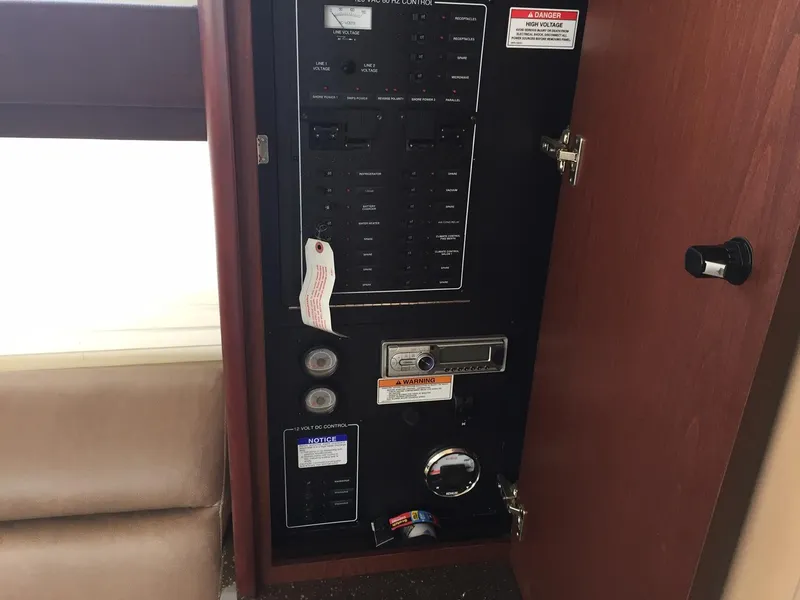 Slide: The Image of Electrical control panel inside 2013 Meridian 341 Sedan yacht, featuring switches and labels. - 26