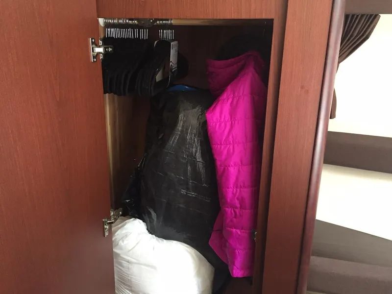 Slide: The Image of Closet inside 2013 Meridian 341 Sedan with pink jacket and hangers. - 33