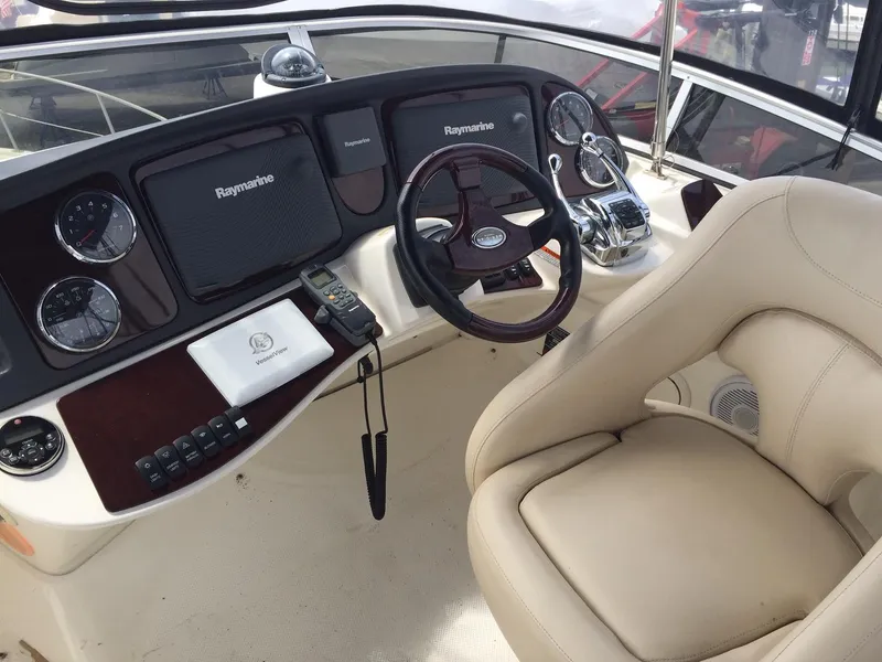 Slide: The Image of 2013 Meridian 341 Sedan helm with Raymarine electronics and beige captain's chair. - 38