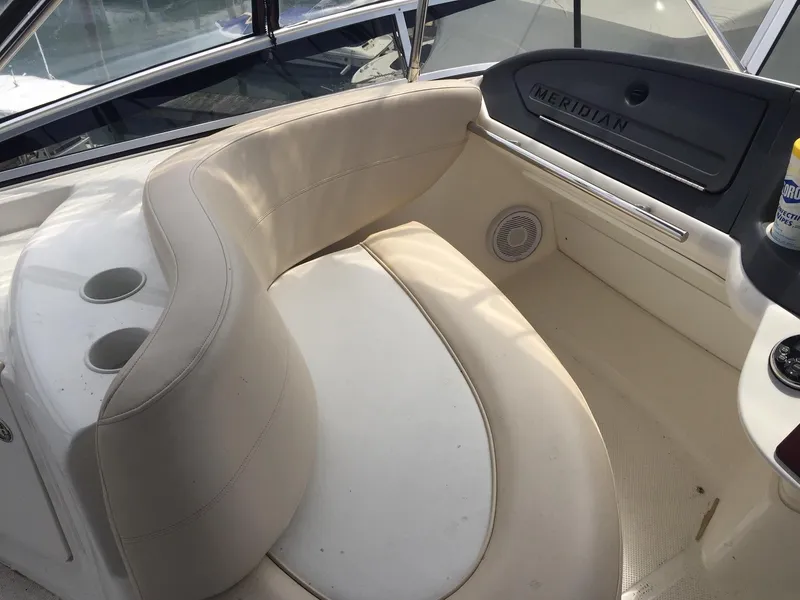 Slide: The Image of 2013 Meridian 341 Sedan boat interior with curved seating and cup holders. - 39
