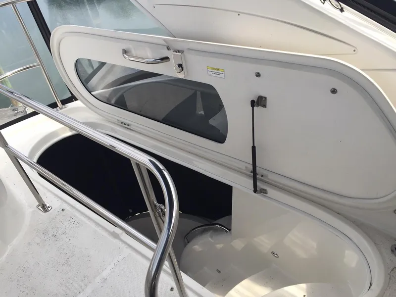 Slide: The Image of 2013 Meridian 341 Sedan yacht hatch with railing and open compartment. - 41