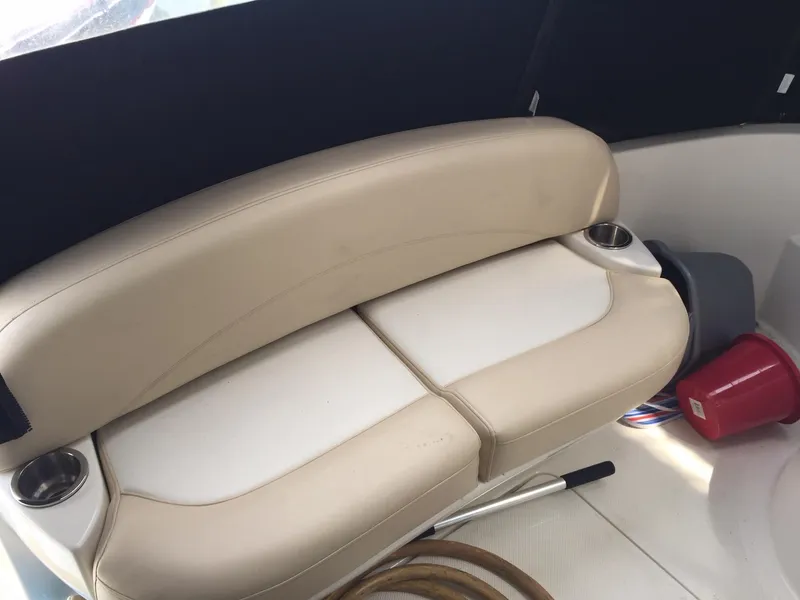 Slide: The Image of Beige seating area on 2013 Meridian 341 Sedan boat with cup holders and accessories. - 49