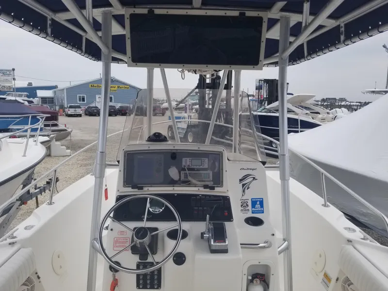 Slide: The Image of 2001 Boston Whaler 23 Outrage boat cockpit with steering wheel and navigation equipment. - 4