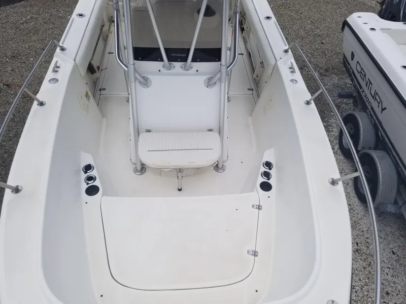 Slide: The Image of 2001 Boston Whaler 23 Outrage boat interior, featuring spacious seating and rod holders. - 6