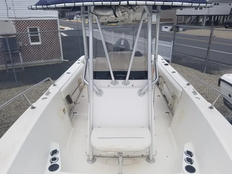 Slide: The Image of 2001 Boston Whaler 23 Outrage boat, center console, docked in a marina. - 7