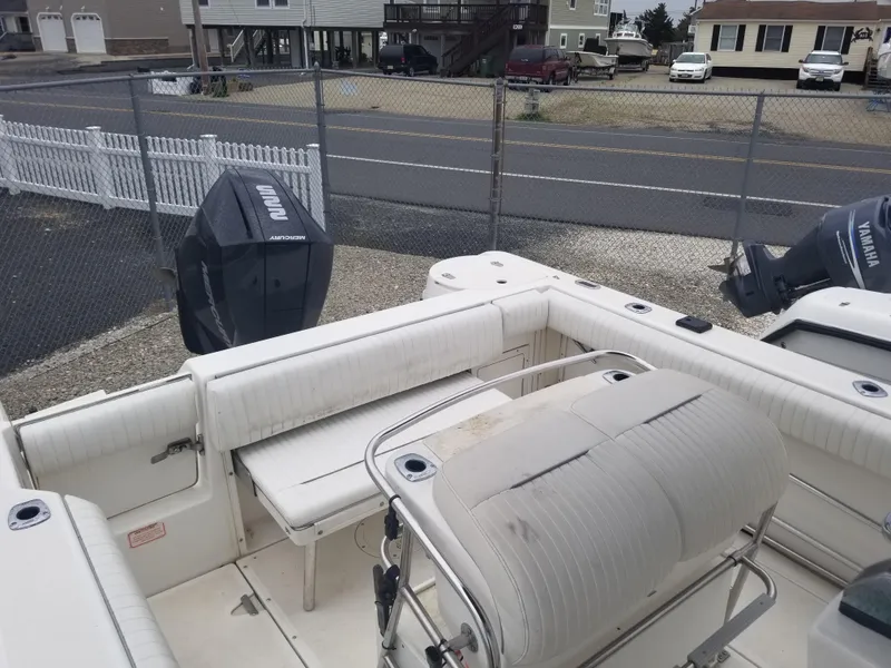 Slide: The Image of 2001 Boston Whaler 23 Outrage boat interior with seating and Yamaha outboard motor. - 9