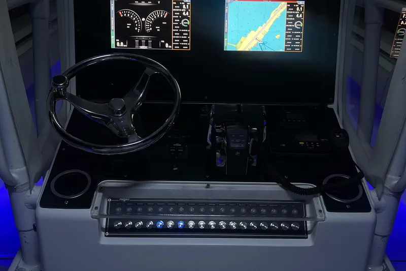 Slide: The Image of Helm of 2008 Invincible 33 boat with navigation screens and controls. - 10