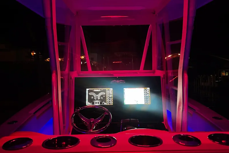 Slide: The Image of Illuminated boat dashboard at night, Invincible 33 model, 2008, with glowing red and blue lights. - 12