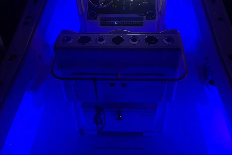 Slide: The Image of Blue-lit interior of a 2008 Invincible 33 boat cockpit at night. - 13