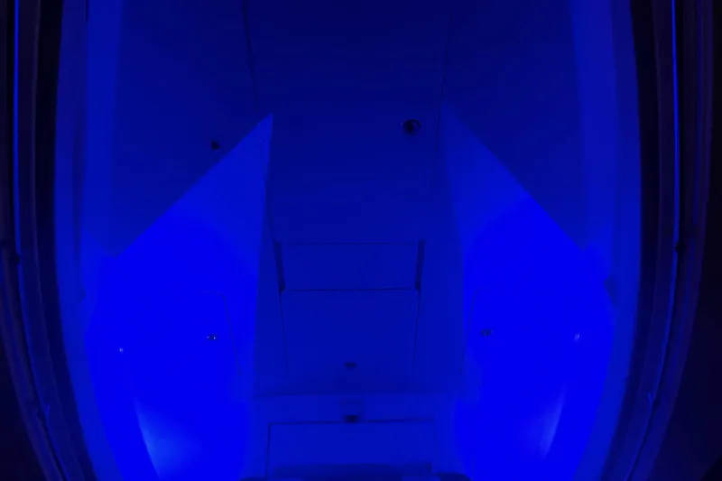 Slide: The Image of Blue-lit interior of a 2008 Invincible 33 boat, showcasing sleek design and modern lighting. - 14
