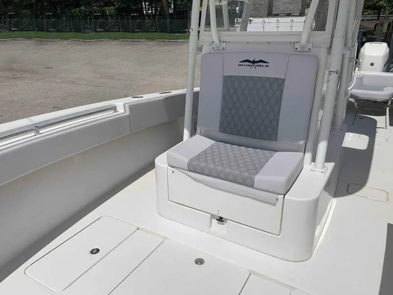 Slide: The Image of 2008 Invincible 33 boat interior with cushioned seating and storage compartment. - 5