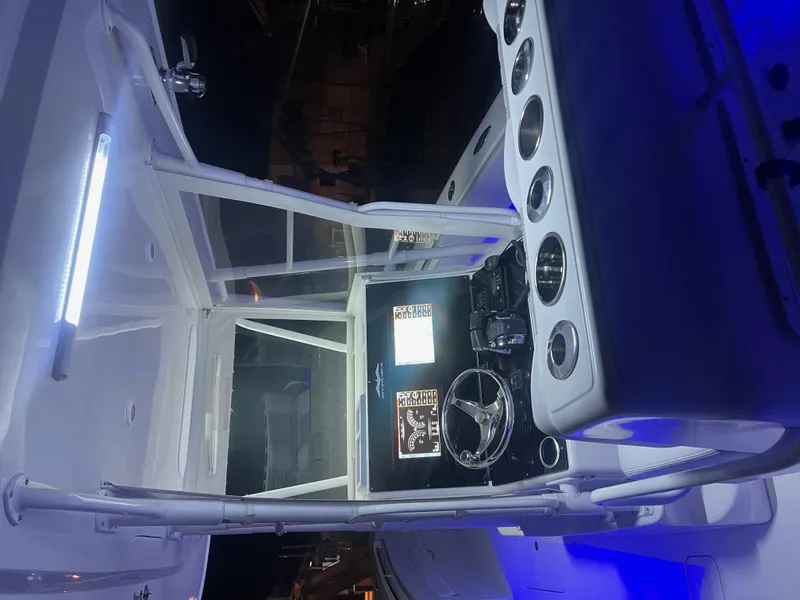 Slide: The Image of 2008 Invincible 33 boat interior with illuminated dashboard and steering wheel. - 8