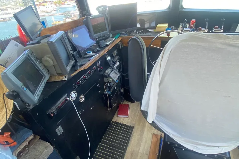 Slide: The Image of 1945 Higgins PT boat cockpit with navigation equipment and captain's chair. - 13