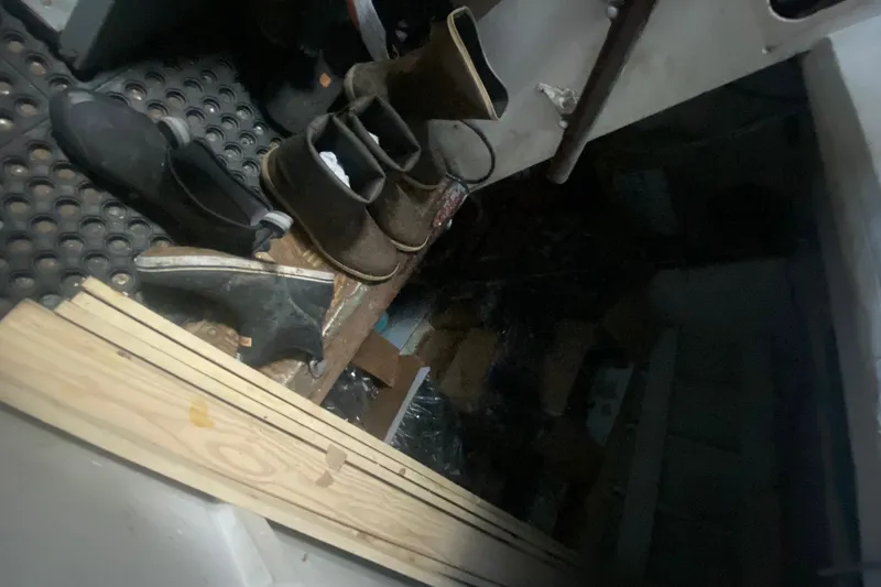 Slide: The Image of Interior of 1945 Higgins PT boat with boots and wooden planks. - 14
