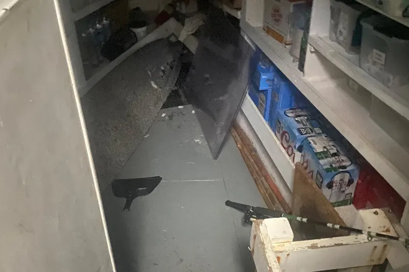 Slide: The Image of Cluttered storage area with shelves, boxes, and miscellaneous items. - 15