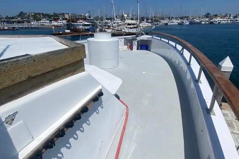 Slide: The Image of 1945 Higgins PT boat docked at a marina with other boats in the background. - 3