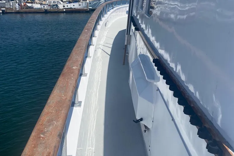 Slide: The Image of 1945 Higgins PT boat deck with wooden railing, docked at a marina. - 4