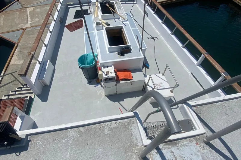 Slide: The Image of 1945 Higgins PT boat deck with equipment and seating at a marina. - 5