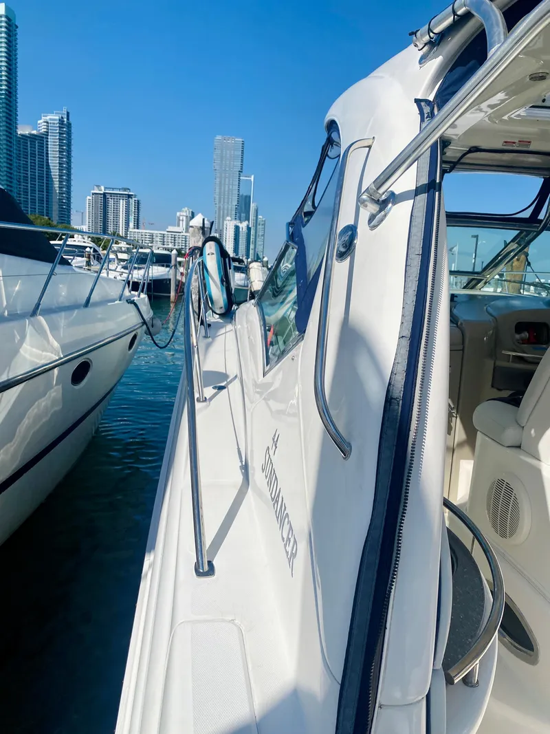 Slide: The Image of 2007 Sea Ray 44 Sundancer yacht docked in a marina with city skyline. - 17
