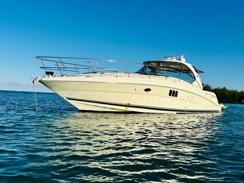 Slide: The Image of 2007 Sea Ray 44 Sundancer yacht anchored on calm waters. - 2