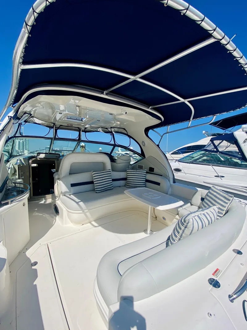 Slide: The Image of 2007 Sea Ray 44 Sundancer yacht with spacious seating and blue canopy. - 21