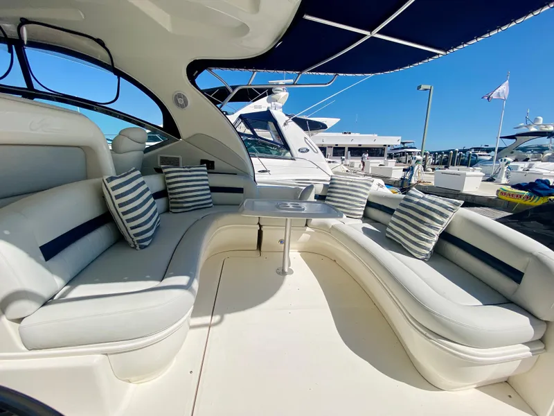 Slide: The Image of 2007 Sea Ray 44 Sundancer yacht with spacious seating area and striped cushions. - 22