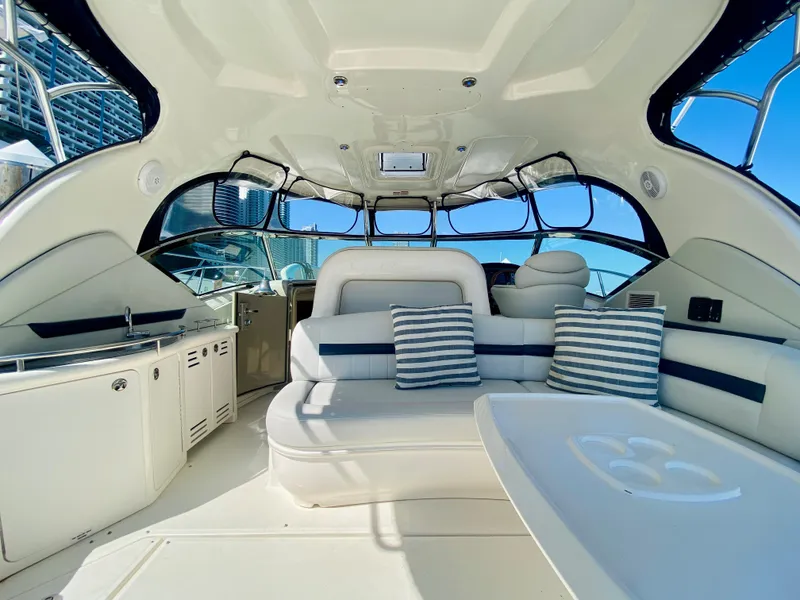 Slide: The Image of Interior of 2007 Sea Ray 44 Sundancer yacht with plush seating and striped cushions. - 23
