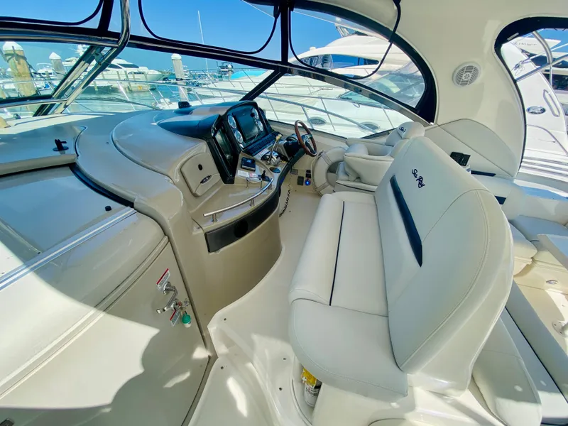 Slide: The Image of 2007 Sea Ray 44 Sundancer yacht cockpit with modern controls and white leather seating. - 26