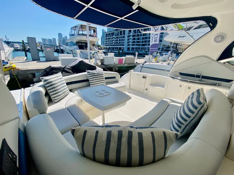 Slide: The Image of 2007 Sea Ray 44 Sundancer yacht with luxurious seating and marina view. - 28