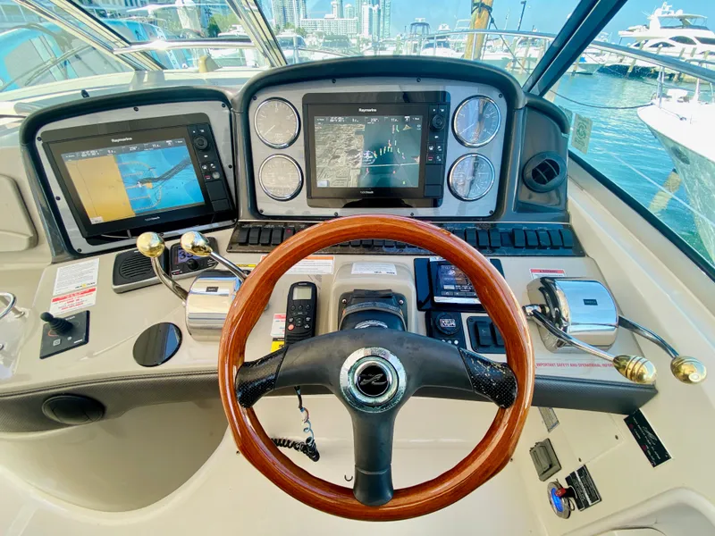 Slide: The Image of 2007 Sea Ray 44 Sundancer helm with navigation screens and controls. - 33