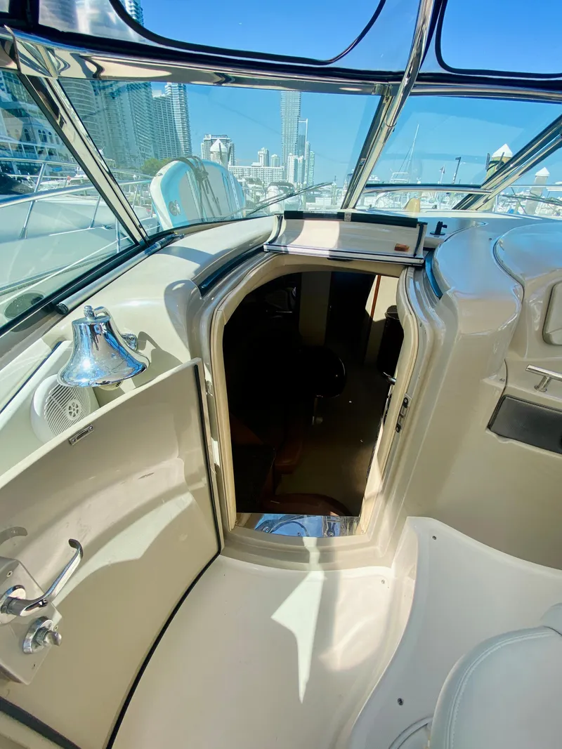 Slide: The Image of 2007 Sea Ray 44 Sundancer cockpit with open cabin door, city skyline in background. - 35