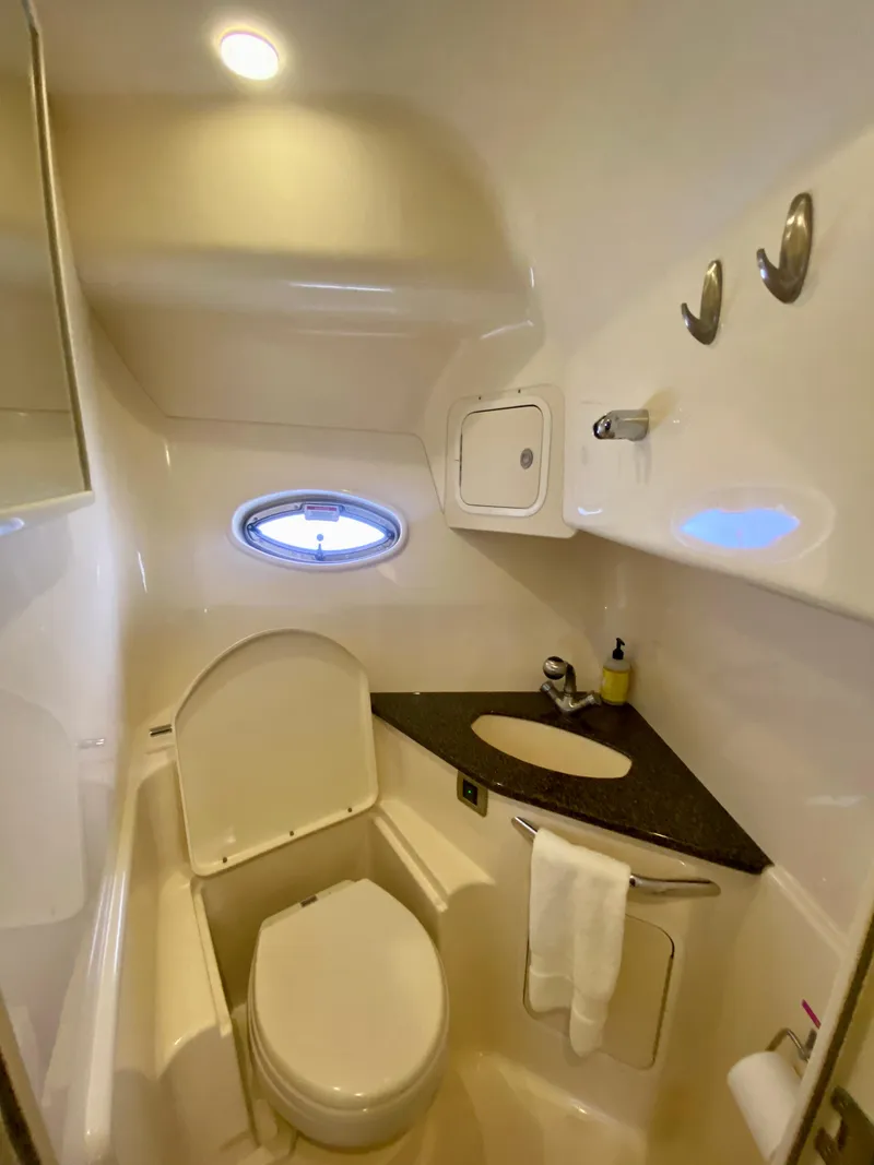 Slide: The Image of 2007 Sea Ray 44 Sundancer bathroom with toilet, sink, and porthole window. - 37